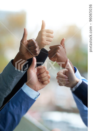 We did it. Shot of a group of unrecognizable coworkers high fiving outside the office. We did it. Shot of a group of unrecognizable coworkers high fiving outside the office. 96065036