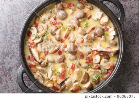 spicy creamy mushroom and bacon gravy on dark stone background. Horizontal top view 96065073