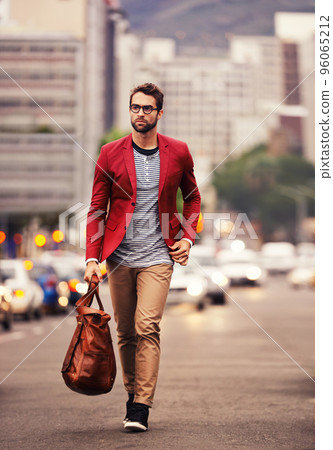 Styled for the city. Shot of a handsome young man taking a walk through the city. Styled for the city. Shot of a handsome young man taking a walk through the city. 96065212
