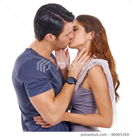 Loves sweet kiss. Studio shot of a young couple kissing isolated on white. 96065269