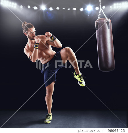 Man is training with the punching bag 96065423