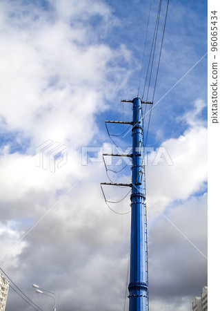 High-voltage power lines of a new sample of blue color against a blue sky on a sunny day. High-voltage power lines of a new sample of blue color against a blue sky on a sunny day. 96065434