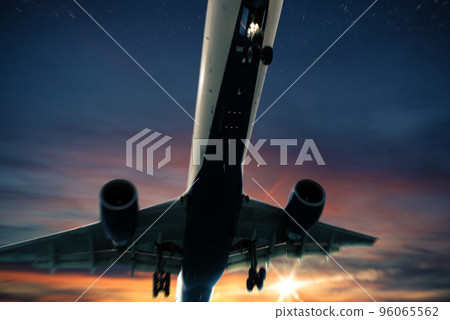 Aircraft flight at sunset 96065562