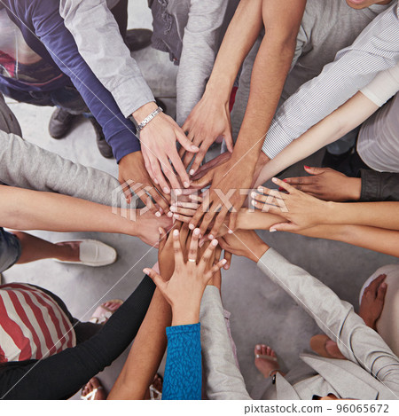 All for one and one for all. Cropped shot of a business team standing in a circle with their hands stacked. 96065672