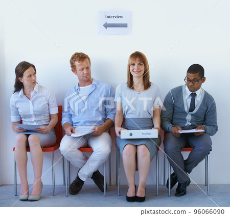 Shes come prepared. Job candidate taking a peak at another candidates resume. Shes come prepared. Job candidate taking a peak at another candidates resume. 96066090