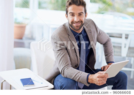 Stop dreaming start doing. Shot of a businessman using his digital tablet. Stop dreaming start doing. Shot of a businessman using his digital tablet. 96066608