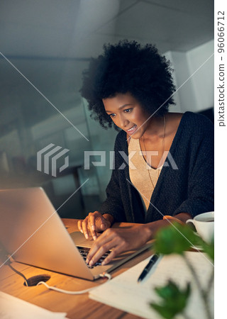 Just editing the last few details before heading home. Cropped shot of a young businesswoman working late on a laptop in an office. Just editing the last few details before heading home. Cropped shot of a young businesswoman working late on a laptop in an office. 96066712