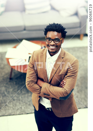 I made the perfect career choice. Portrait of a confident young businessman standing in an office. 96066719