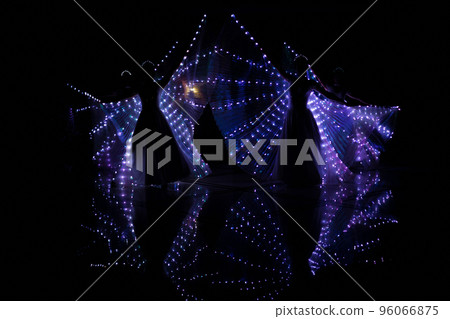Laser show performance, dancers in suits with LED lamp, very beautiful night club party. 96066875