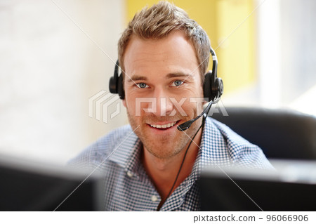 He knows how to sell your product. Portrait of a male customer service representative at his computer. 96066906