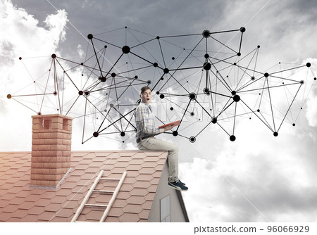 Man on brick roof reading book and concept of social connection 96066929