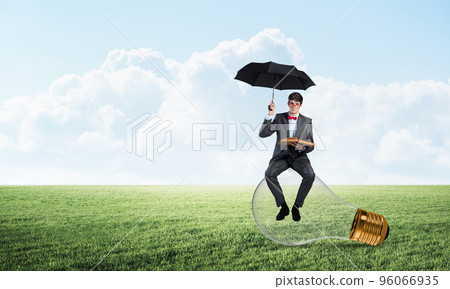 young businessman with an umbrella and a book young businessman with an umbrella and a book 96066935