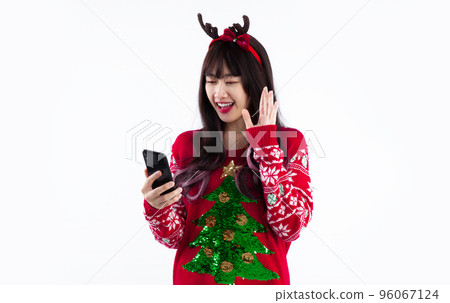 Asian woman in christmas theme costume using chatting smartphone on white background. 96067124