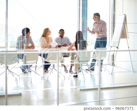 Enthusiastic about their latest project. Full length shot of a group of business colleagues in a boardroom meeting. 96067371