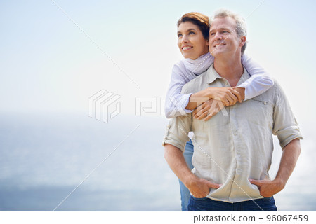 Looking forward to the future together. A happy mature couple with their heads together affectionately. Looking forward to the future together. A happy mature couple with their heads together affectionately. 96067459