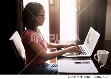 Working from home is more efficient for her. Cropped shot of an attractive young businesswoman working from home. 96067473