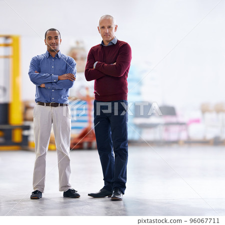 Meet the inspectors. Portrait of two factory managers doing a warehouse inspection. Meet the inspectors. Portrait of two factory managers doing a warehouse inspection. 96067711