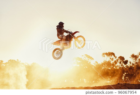 Hes way out in front. A shot of a motocross rider in midair during a race. 96067954