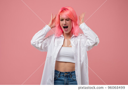 Irritated pink-haired girl screaming during the photo shoot Irritated pink-haired girl screaming during the photo shoot 96068499