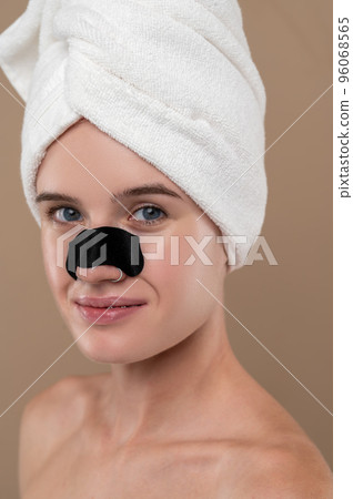 Close up of a girl with a cleansing nose stripe 96068565