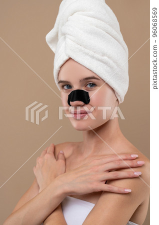 Young cute girl with a cleansing stripe on her nose 96068569