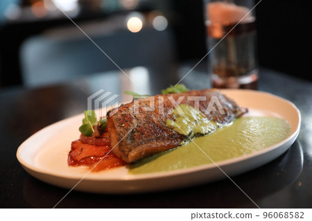 Sea bass fillet with pesto sauce Sea bass fillet with pesto sauce 96068582