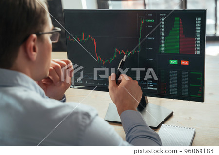 Financial analyst and trader examining attentively investment graph trying to predict money flow Financial analyst and trader examining attentively investment graph trying to predict money flow 96069183
