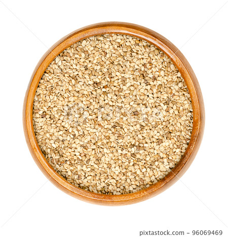 Unhulled sesame seeds, benne in a wooden bowl. Seeds of Sesamum indicum, with rich and nutty flavor. Common ingredient in cuisines around the world, with one of the highest oil content of any seed. Unhulled sesame seeds, benne in a wooden bowl. Seeds of Sesamum indicum, with rich and nutty flavor. Common ingredient in cuisines around the world, with one of the highest oil content of any seed. 96069469