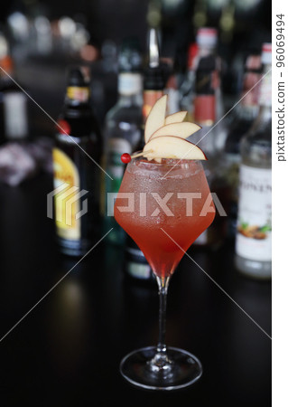 Pink Cocktail glass with ice at a bar counter 96069494