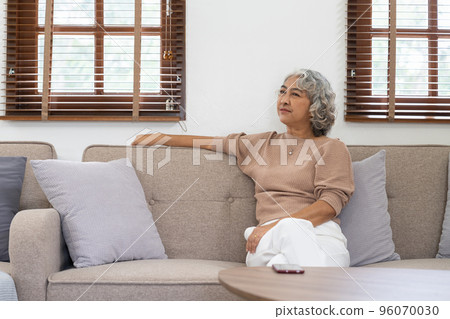 Asian elderly senior female at nursing home living room feeling sad missing unhappy thoughtful in mental health care in older people. Asian elderly senior female at nursing home living room feeling sad missing unhappy thoughtful in mental health care in older people. 96070030