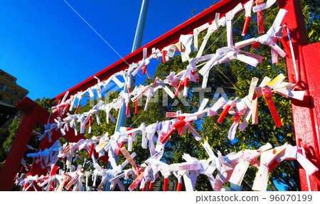 Many omikuji fortune slips and blue sky scenery Many omikuji fortune slips and blue sky scenery 96070199