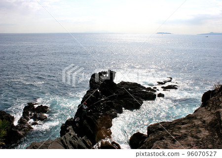 Standing on the tip of the shore and fishing for porgies Standing on the tip of the shore and fishing for porgies 96070527