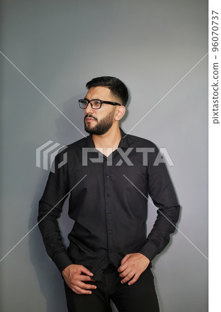Young handsome business man dressed in casual denim shirt with smartwatch on wrist 96070737