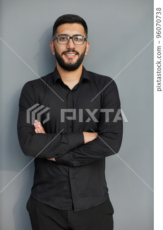 Young handsome business man dressed in casual denim shirt with smartwatch on wrist Young handsome business man dressed in casual denim shirt with smartwatch on wrist 96070738