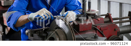 Young man sanding or iron at industrial factory, mechanic working job while polish metal. Young man sanding or iron at industrial factory, mechanic working job while polish metal. 96071124