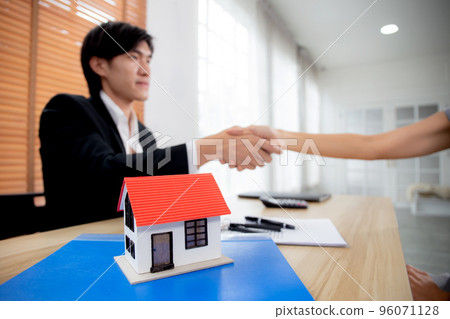 Real estate agent man and customer woman handshake together after agreement success. Real estate agent man and customer woman handshake together after agreement success. 96071128