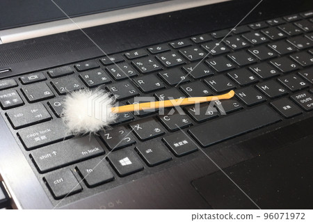 Earpick placed on a computer keyboard 96071972