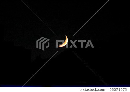 Crescent moon floating in the night sky 96071973
