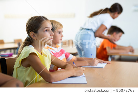 Boy and girl studying in classroom Boy and girl studying in classroom 96072762