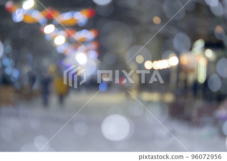 Blurred background. City street during snowfall at winter night. Many decorated Christmas trees, illumination, decoration on street. New Year Christmas holidays celebration. Lanterns garlands on trees 96072956