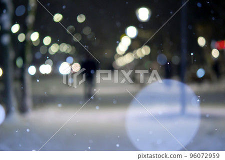 Blurred background. City view, lights, falling snow, night, street, bokeh spots of headlights of moving cars. Diffuse Urban backdrop winter scenery of street in city at night. Lantern light, snowfall 96072959