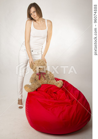 Young woman in white tight clothes posing in studio Young woman in white tight clothes posing in studio 96074888