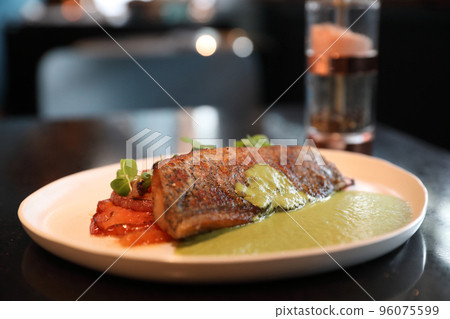 Sea bass fillet with pesto sauce Sea bass fillet with pesto sauce 96075599