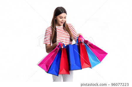 surprised teen girl shopper with shop bag isolated on white background. shopper girl 96077223