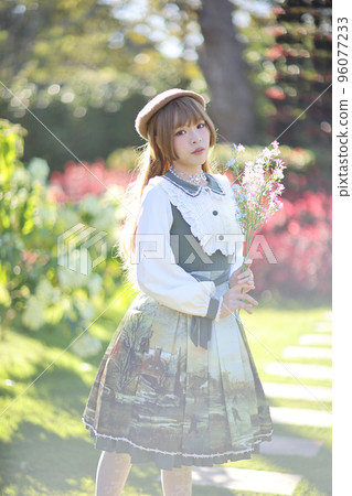 A beautiful woman in lolita dress in garden background Japanese street fashion portrait A beautiful woman in lolita dress in garden background Japanese street fashion portrait 96077233