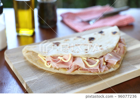 Italian cuisine , Piadina with Italian ham and cheese Italian cuisine , Piadina with Italian ham and cheese 96077236
