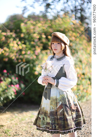 A beautiful woman in lolita dress in garden background Japanese street fashion portrait A beautiful woman in lolita dress in garden background Japanese street fashion portrait 96077400