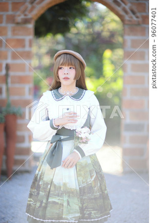 A beautiful woman in lolita dress in garden background Japanese street fashion portrait A beautiful woman in lolita dress in garden background Japanese street fashion portrait 96077401