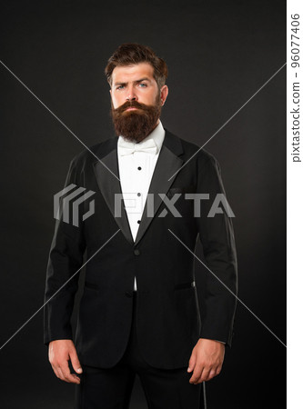 bearded businessman in tuxedo on black background, tux 96077406