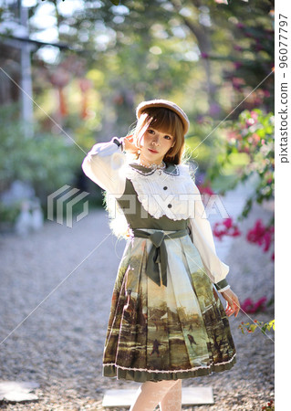 A beautiful woman in lolita dress in garden background Japanese street fashion portrait A beautiful woman in lolita dress in garden background Japanese street fashion portrait 96077797